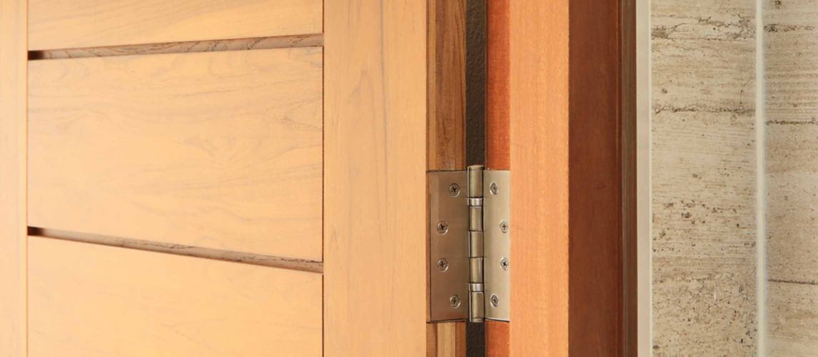 Stainless door hinges on wooden door