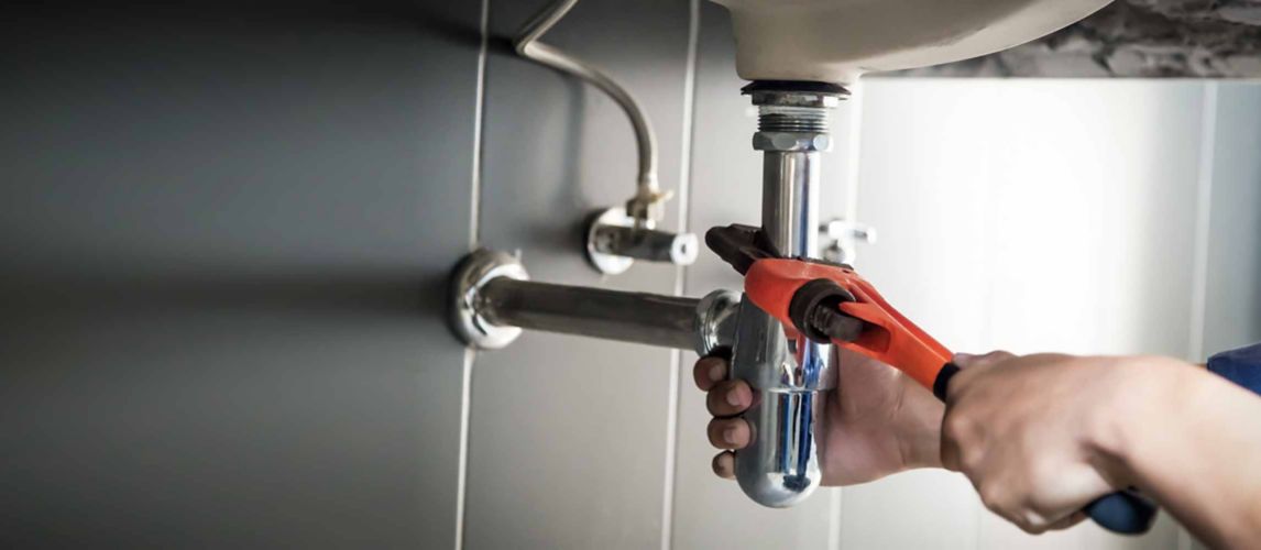 fixing water pipes underneath a sink