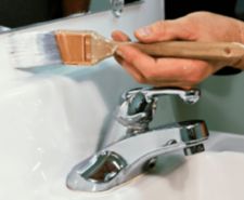 person painting bathroom sink