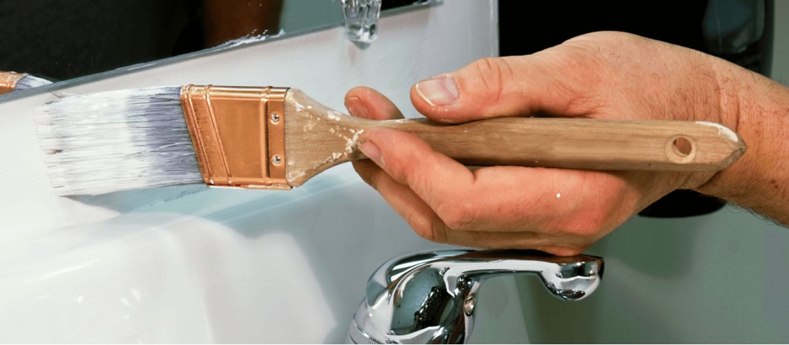 person painting bathroom sink
