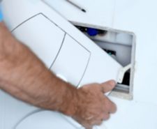 A DIY-er adding an inspection panel after boxing in pipes at home