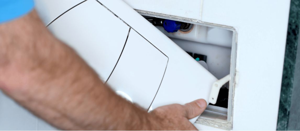 A DIY-er adding an inspection panel after boxing in pipes at home