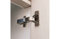 Detail of concealed hinge on cabinet door.