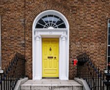 yellow front door on street