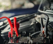 Jump leads connected to a cars battery
