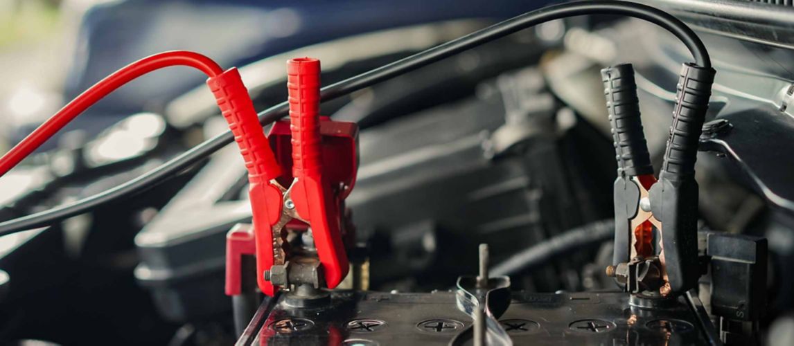 Jump leads connected to a cars battery