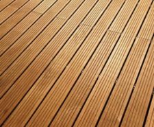 Brown wooden decking boards installed with uniform gaps between the planks