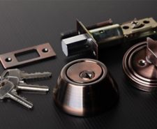 Various door lock parts including a deadbolt door lock and keys