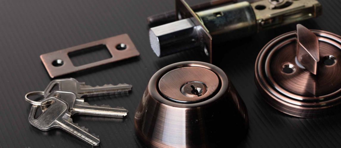 Various door lock parts including a deadbolt door lock and keys