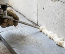 person using an expanding foam gun