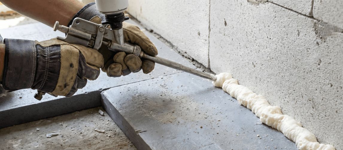 person using an expanding foam gun
