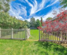 person wearing gloves moving soil in garden