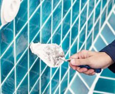 Hand of person grouting tiles