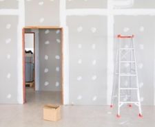 Dot and dab plasterboarding finished on a wall with a door