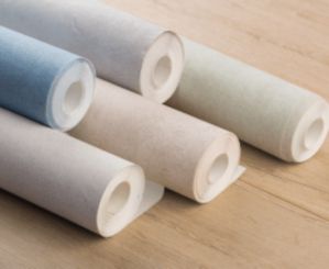 rolls of wallpaper on floor