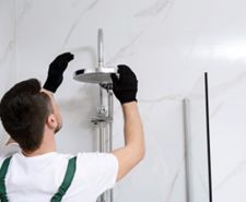 man installing a shower head