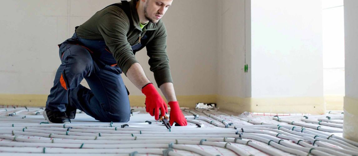 Worker installing underfloor heating.