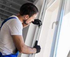 man installing rubber seal on upvc window