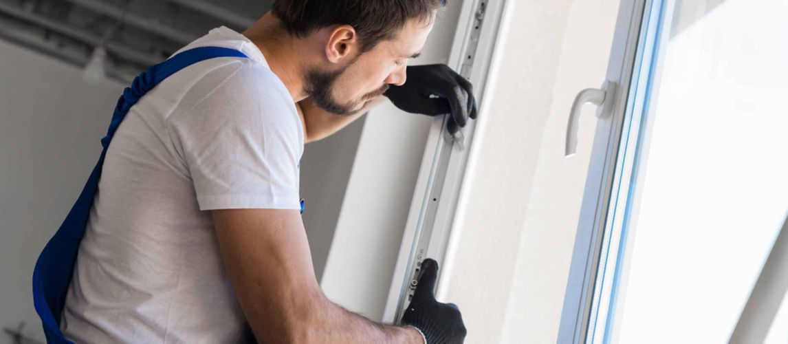 man installing rubber seal on upvc window