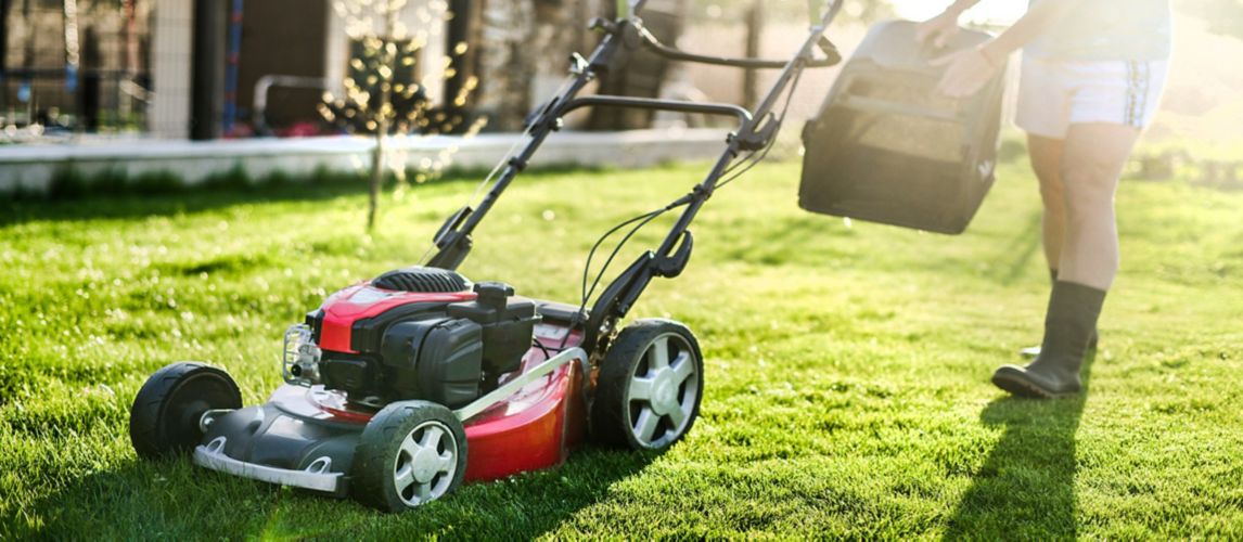 Image a man mowing the lawn