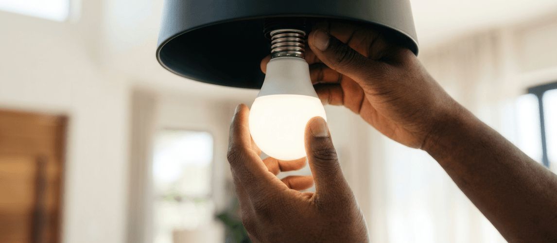 person changing a lightbulb