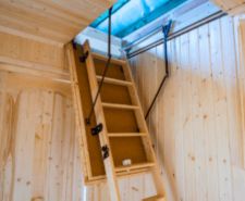 Wooden loft ladder installed in ceiling.