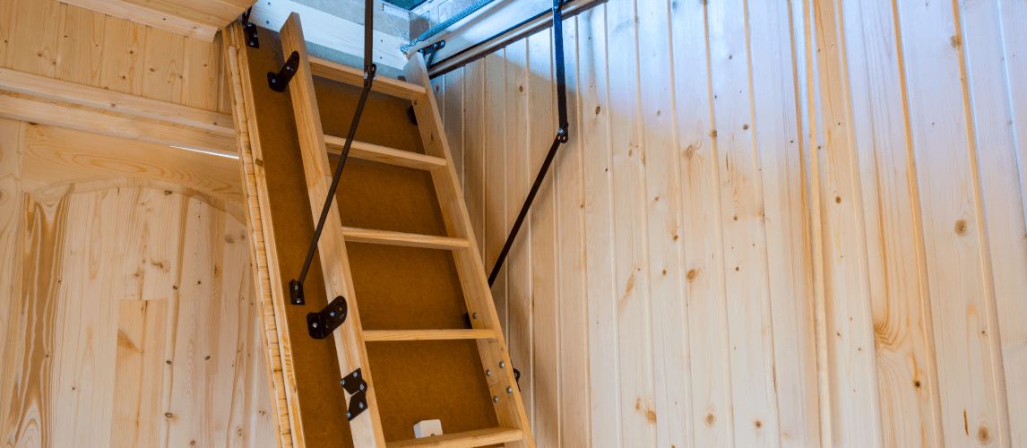 Wooden loft ladder installed in ceiling.