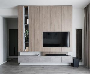 Modern living room with media wall and television.