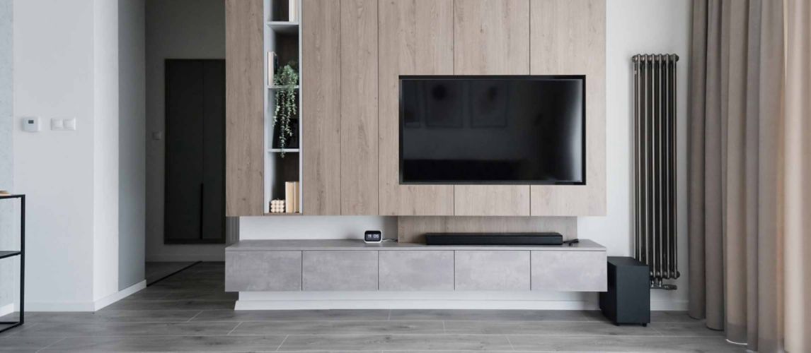 Modern living room with media wall and television.