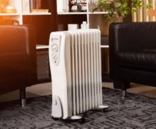 Oil-filled electrical mobile radiator heater in the middle of a living room