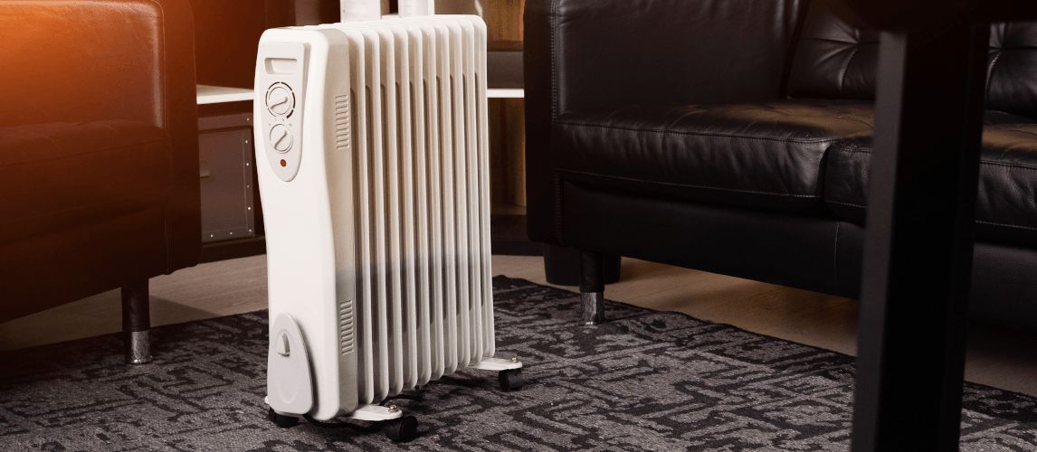 Oil-filled electrical mobile radiator heater in the middle of a living room