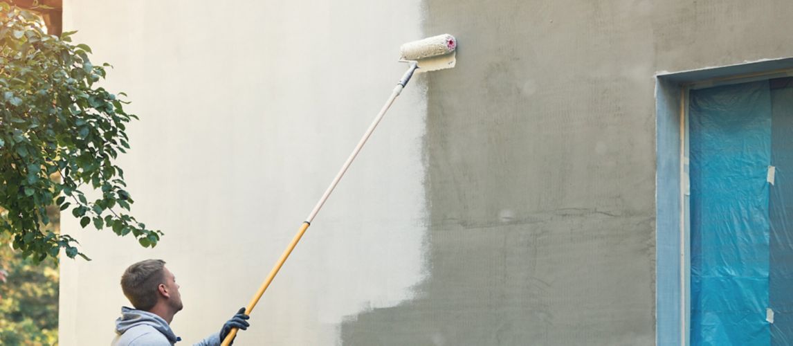 Image of someone painting outside wall