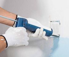 caulk being applied around socket