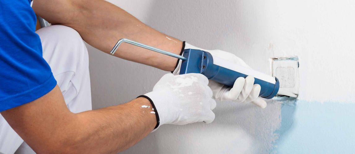 caulk being applied around socket