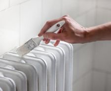 close up of hand painting a radiator