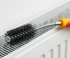 radiator cleaning brush balancing on top of radiator