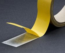 Double sided tape being applied onto surface