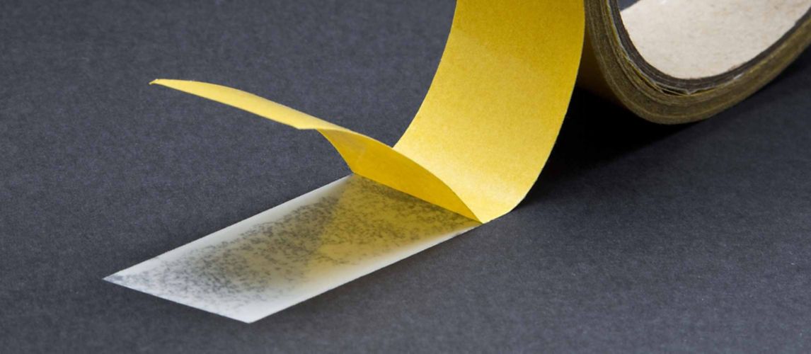 Double sided tape being applied onto surface