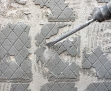 SDS drill being used to remove tile adhesive from a wall