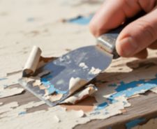 Removing paint from wood using a scraper