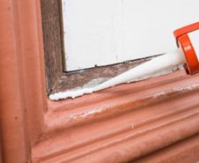 Sealant being applied on window frame