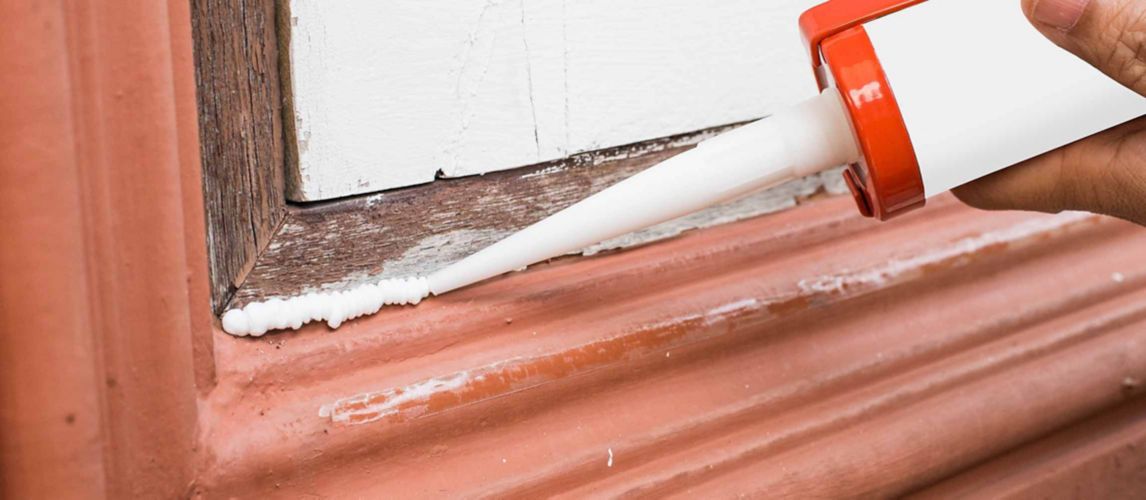 Sealant being applied on window frame