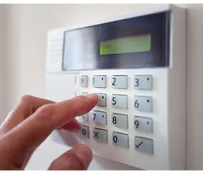 Hand pressing button on alarm