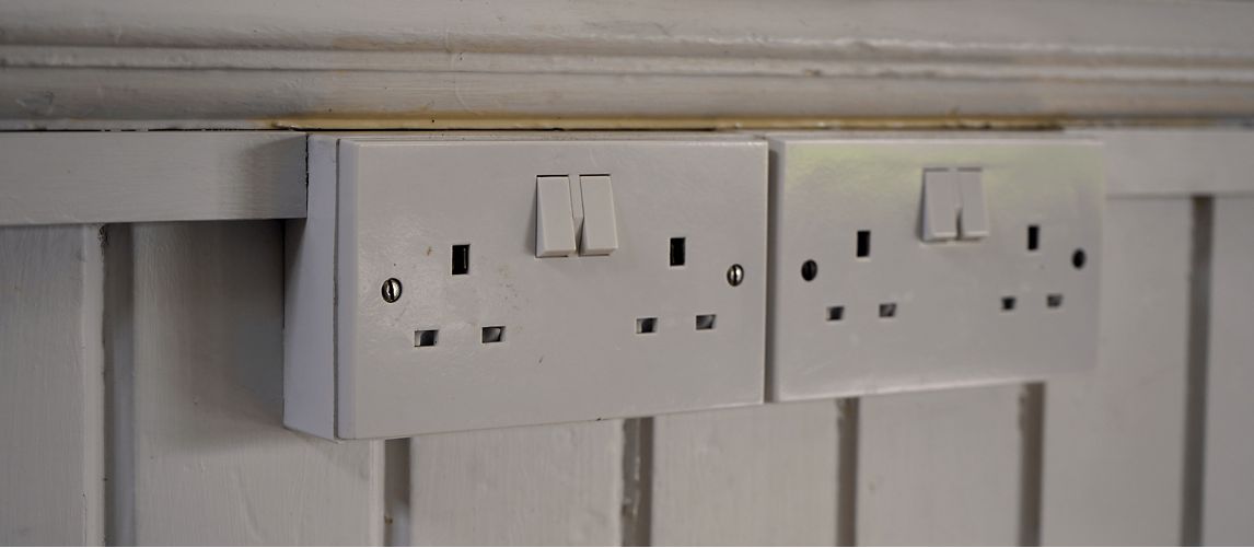 two white double sockets on a wall