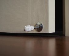 Door spring stopper on a white door.