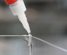 super glue being applied to glass
