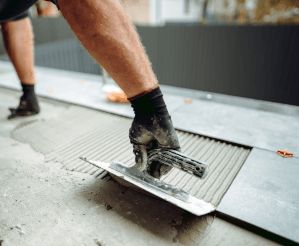 person tiling floor