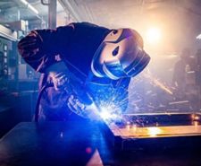 Man in work shop welding