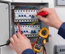 Electrician working on electrical panel