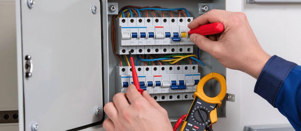 Electrician working on electrical panel